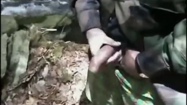 Soldier strokes dick in forest