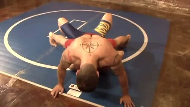 Lecherous wrestlers fuck in a gym