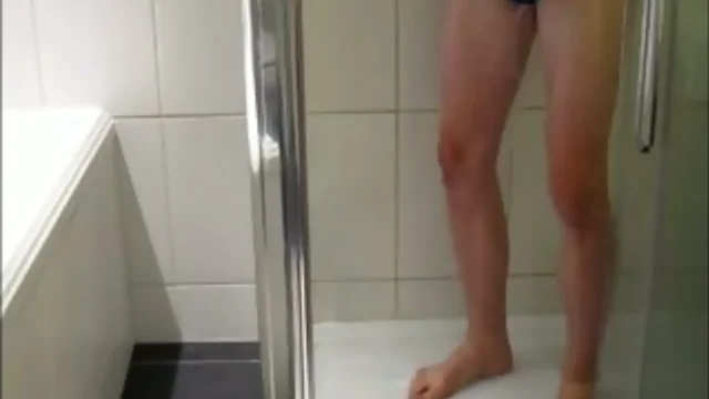 Sexy guy plays naughtily in a shower