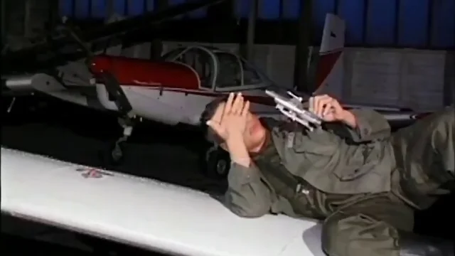 Mischievous pilots pound each other in a hangar