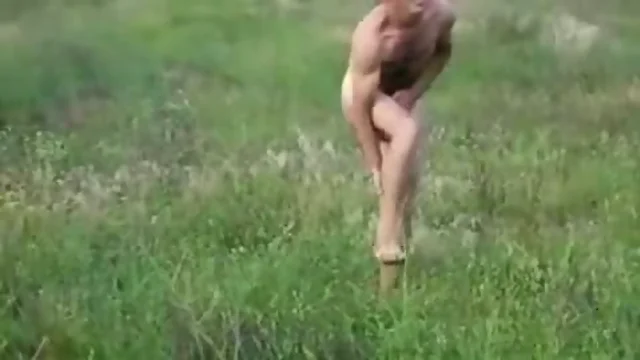 Naked in a grassy field