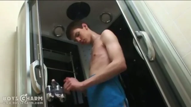 Bold teenager enjoys a lovely tug job in a shower cabin