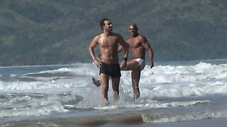 Ebony stud with six pack rides partner's cock in the sand