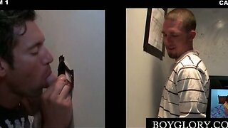 Cute gay brunette giving oral sex on gloryhole