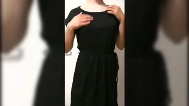 Thin young in cute dress doing striptease