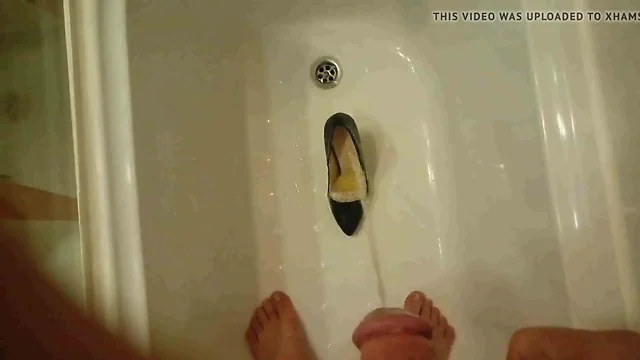 Pissing into wife's black pumps at a hotel room tub