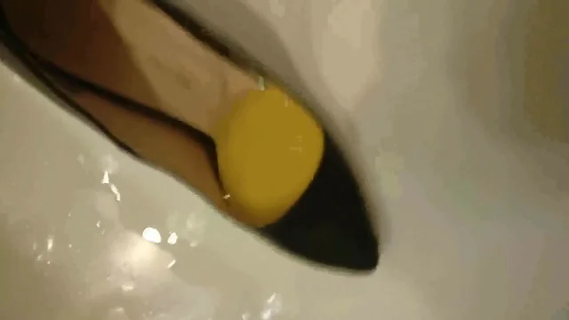 Pissing into wife's black pumps at a hotel room tub