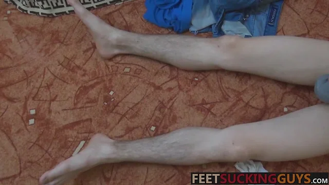 Hung twink Eryk is playing with his feet and big uncut cock