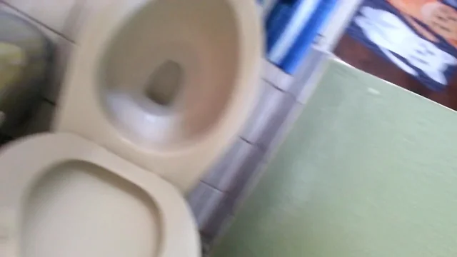 Fat boy rubs his stubby cock and cums into the toilet