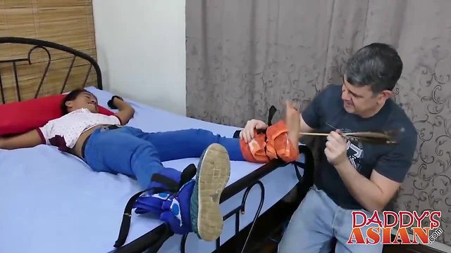 Dad tickles boy feet before hard butt pounding commences