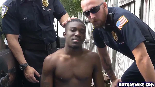Two police officers take advantages of this ebony guy