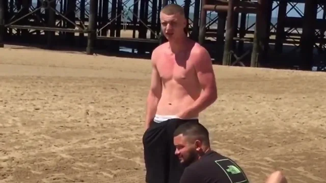 Aroused shirtless dude adjusts his bulge in front of his friends