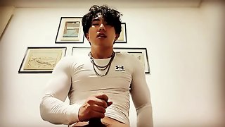 Asiatic man in gym attire pleasuring himself and achieving intense orgasm