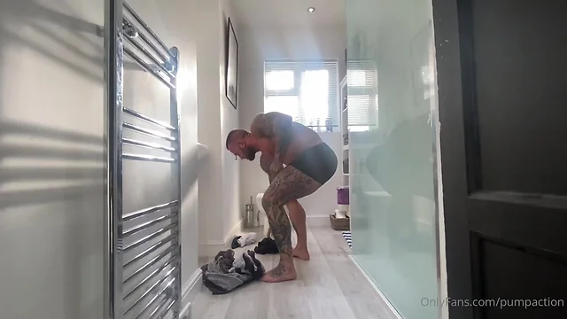 Athletic man showering: clockstopping moment