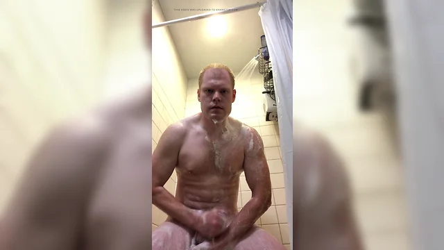 Redheaded man pleasures himself in the shower with your image.