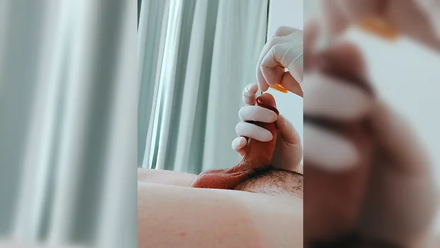 Putting on latex medical gloves while pumping a penis
