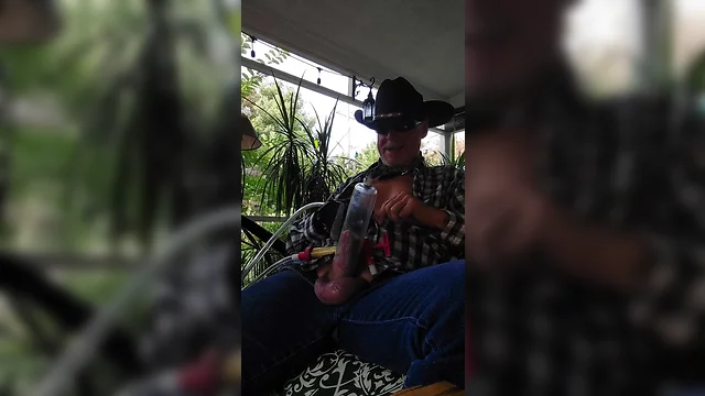 Cowboy dad milks rooster and relaxes on back porch