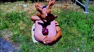 Outdoor bdsm cbt: pervert slave pig with exposed penis cage and dildo in ass