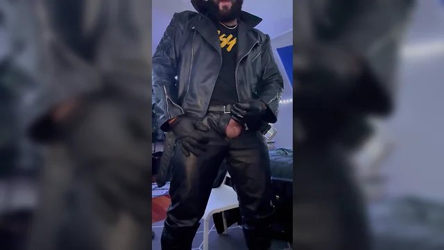 Man in leather jacket masturbating