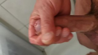 Close-up uncut male masturbation with squirting, peeing, and creamy cumshot
