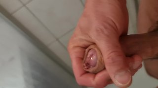 Close-up uncut male masturbation with squirting, peeing, and creamy cumshot