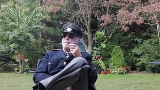 Military officer relaxes with pipe smoking