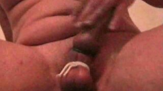 Tied balls guy masturbates cock