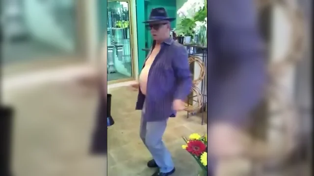 Nasty mature man dances in a flowershop